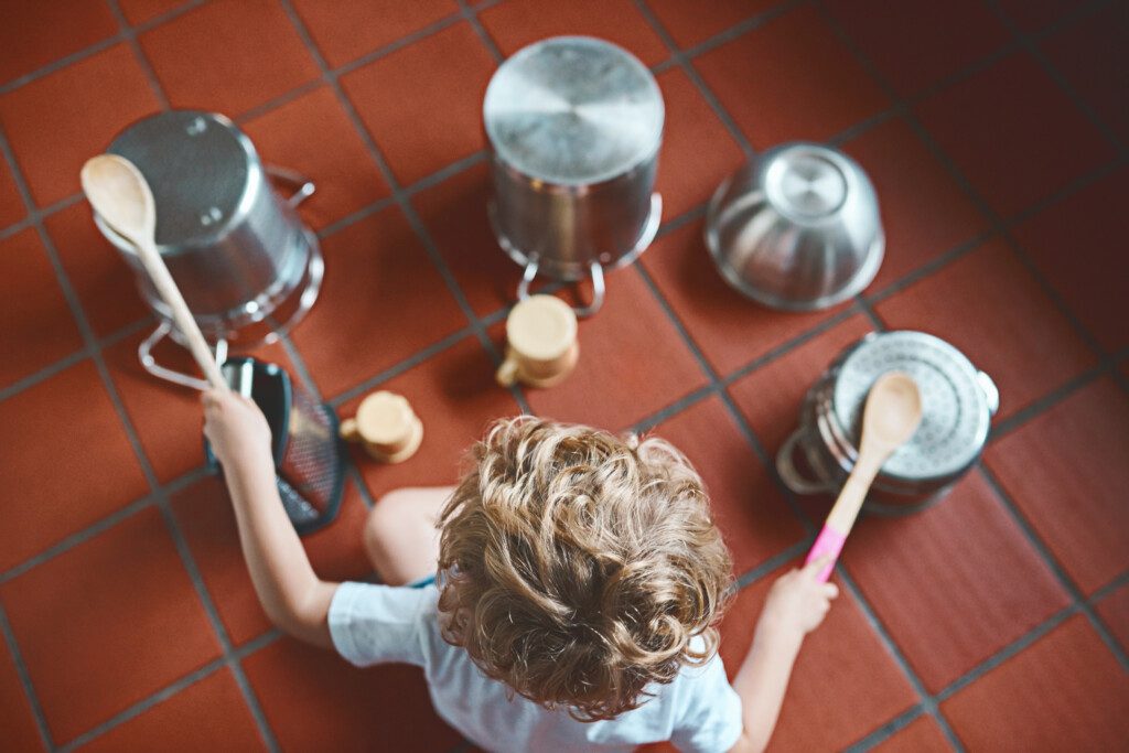 Child making music with pots and pans